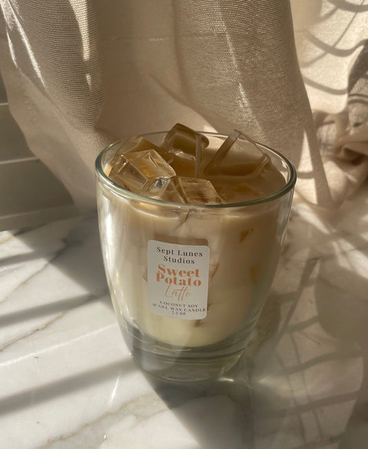 Iced coffee with a sweet potato flavor label on a marble surface with curtains in the background